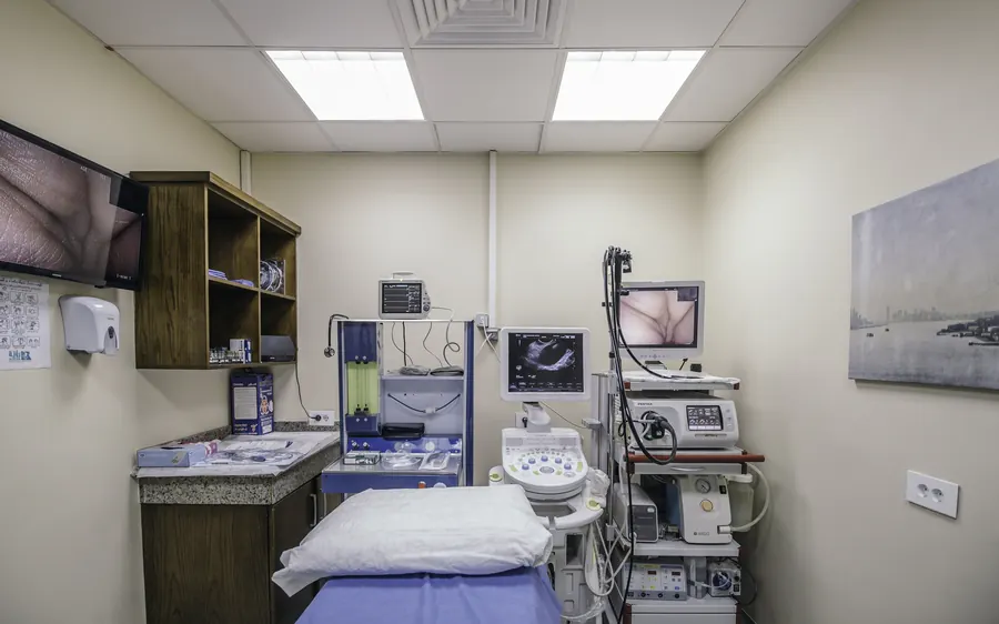 An endoscopy room with the patient bed and the endoscopy tower