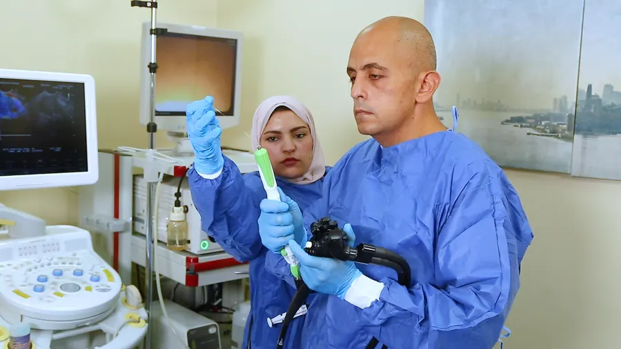 An endoscopist and a nurse with an endoscope