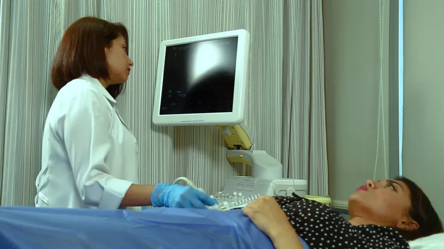 A doctor performs an ultrasound scan on a patient